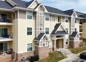 Thumbnail 3 of 31 - an exterior view of an apartment building with balconies at The Fountains Apartments, Pensacola, Florida, 32514